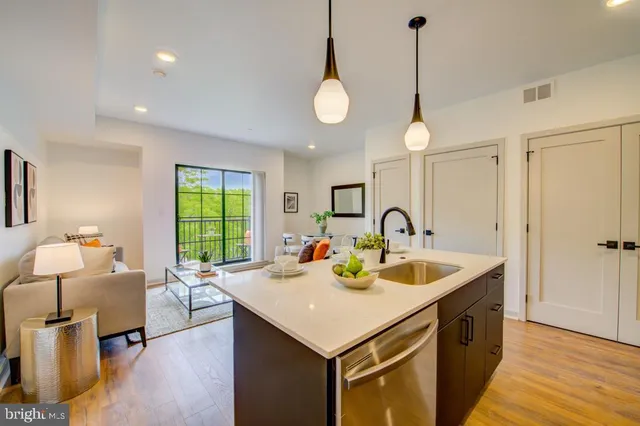 a view of kitchen island a sink and living room view