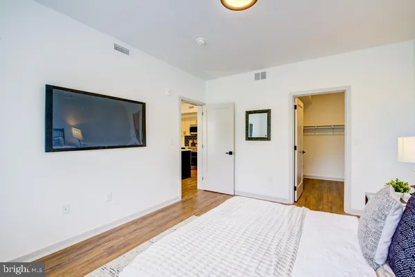 a bedroom with a bed and a flat screen tv
