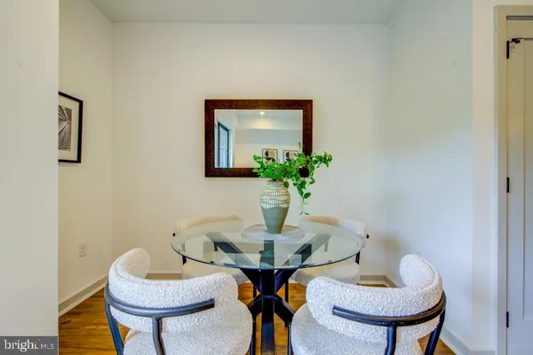 a dining room with furniture and a potted plant