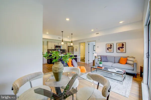 a living room with furniture a flowers and a dining table