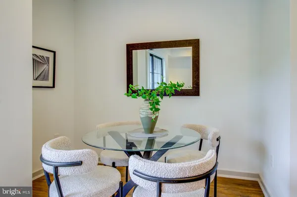 a dining room with furniture and wooden floor