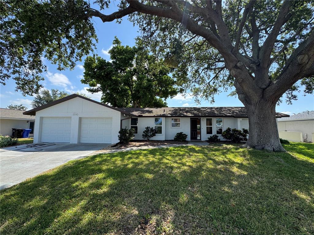 1238 Waterside Lane Venice, FL 34285 - Photo 1 of 1 a house view with a sitting space and a large tree