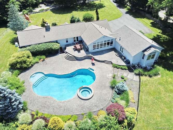 an aerial view of a house with garden space and street view