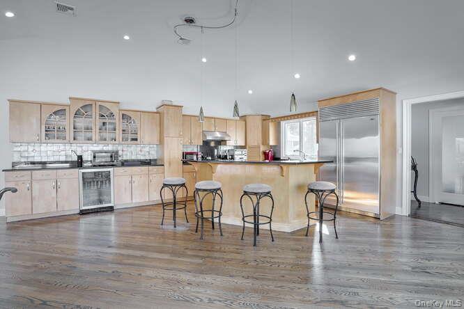 89 Spook Rock Road Suffern, NY 10901 - Photo 13 of 42 a kitchen with white cabinets and stainless steel appliances