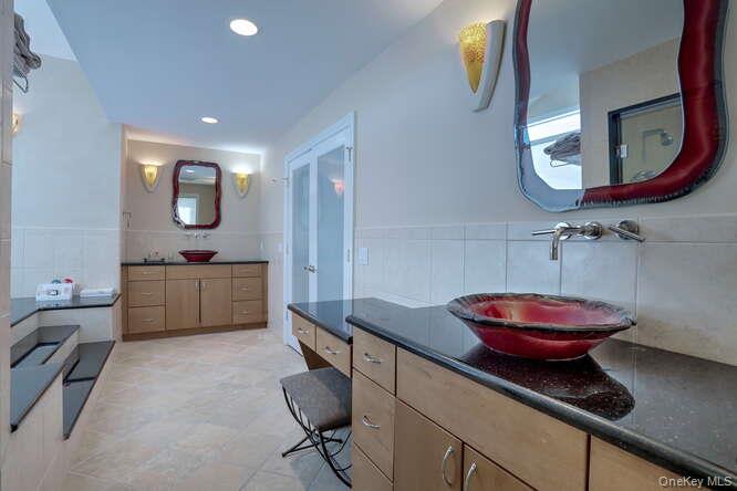 89 Spook Rock Road Suffern, NY 10901 - Photo 21 of 42 a bathroom with a toilet a sink and mirror