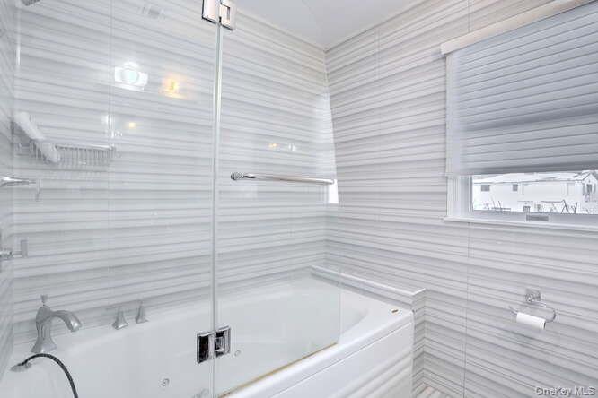 89 Spook Rock Road Suffern, NY 10901 - Photo 24 of 42 a bathroom with a bathtub and shower