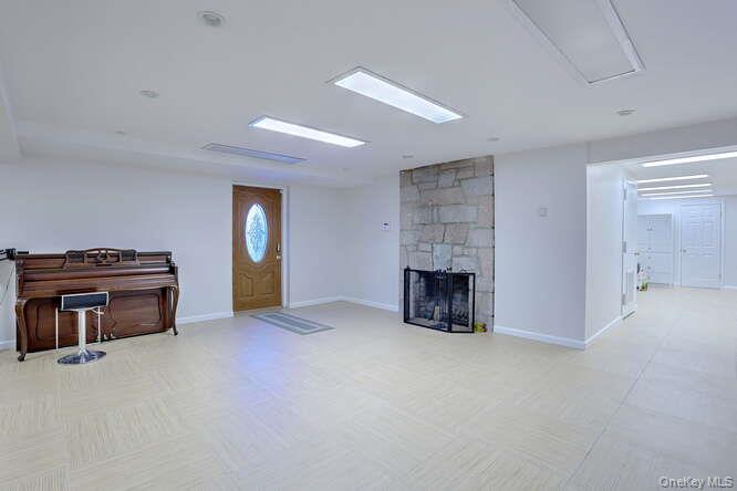 89 Spook Rock Road Suffern, NY 10901 - Photo 31 of 42 a view of an empty room with fire place and a fireplace