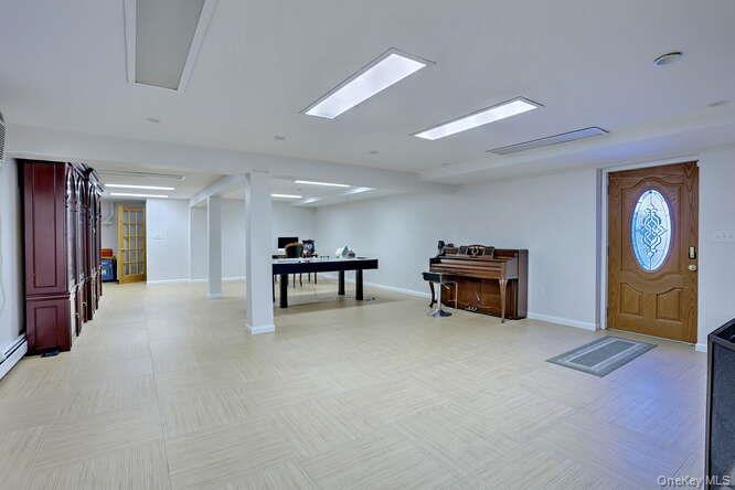 89 Spook Rock Road Suffern, NY 10901 - Photo 32 of 42 a living room with furniture a ceiling fan and a wooden floor