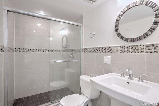 89 Spook Rock Road Suffern, NY 10901 - Photo 33 of 42 a bathroom with a sink mirror toilet and shower