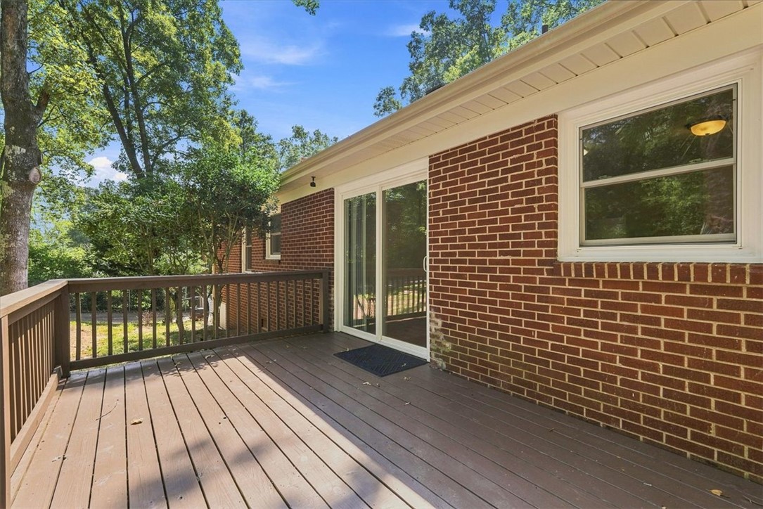 322 Pendleton Road Clemson, SC 29631 - Photo 16 of 26 A spacious wooden deck extends from the brick exterior, offering peaceful wooded views.