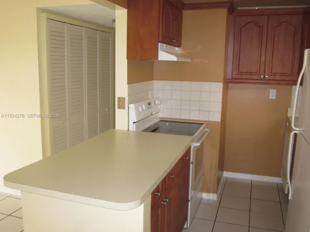 a kitchen with white cabinets and a sink