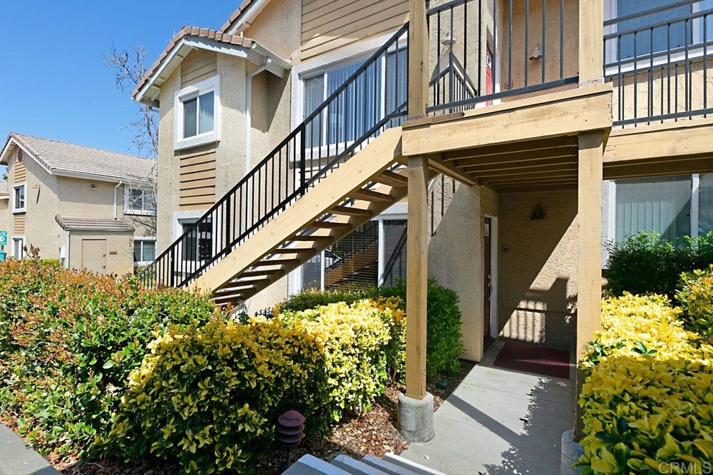 505 San Pasqual Valley Road, Unit 169 Escondido, CA 92027 - Photo 1 of 1 a view of building along with potted plants
