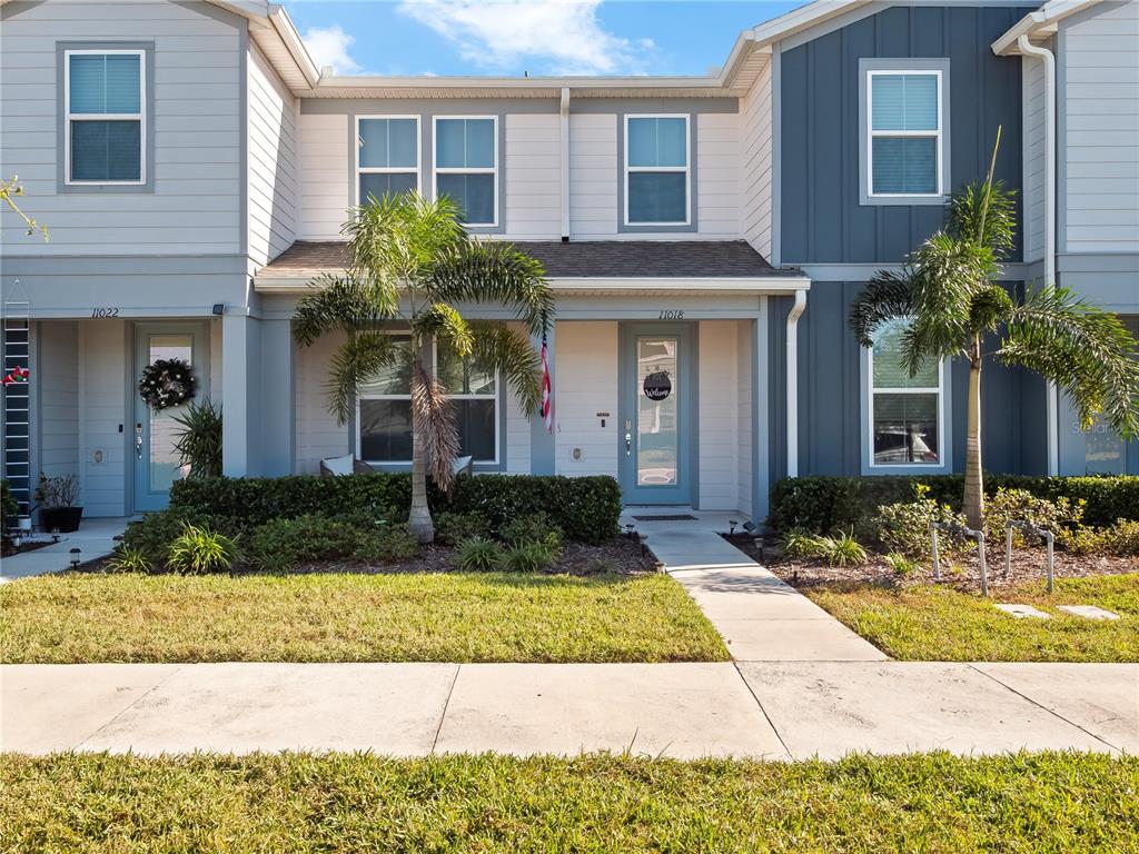 11018 Leafshore Loop Orlando, FL 32829 - Photo 1 of 24 a front view of a house with yard and glass windows
