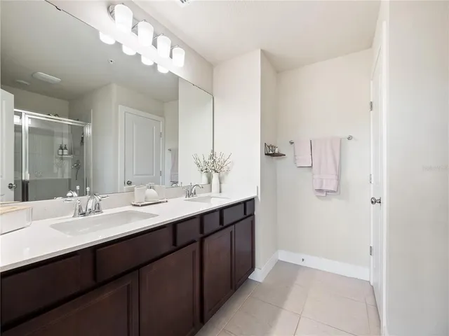 a bathroom with a double vanity sink and a mirror