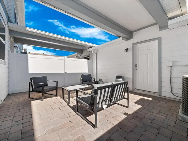 a view of a patio with a table and chairs