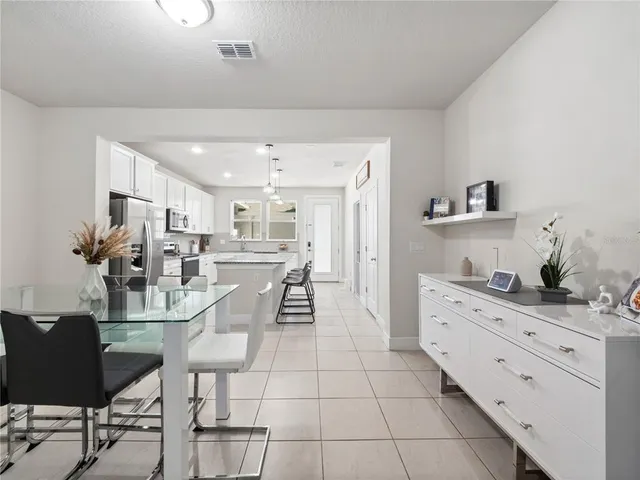 a kitchen with stainless steel appliances kitchen island granite countertop a refrigerator and cabinets