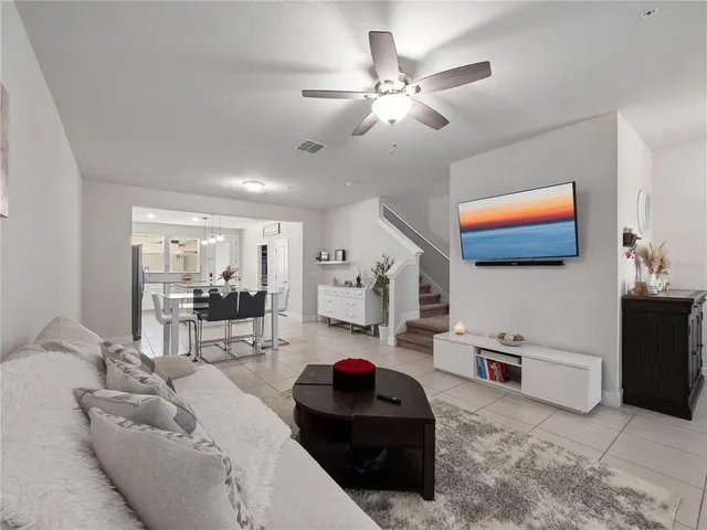 a living room with furniture and kitchen view