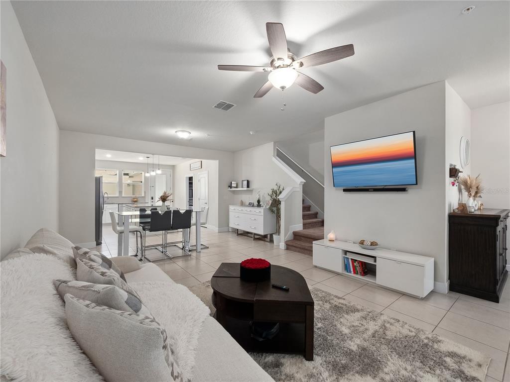 11018 Leafshore Loop Orlando, FL 32829 - Photo 8 of 24 a living room with furniture and kitchen view