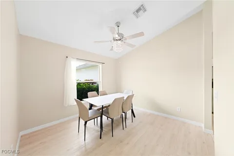 a view of a dining room with furniture and chandelier