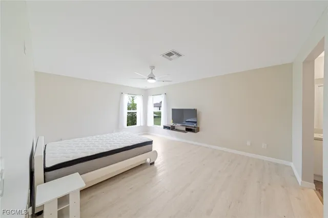a bedroom with furniture and a flat screen tv