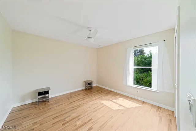 a view of a room with a window and wooden floor