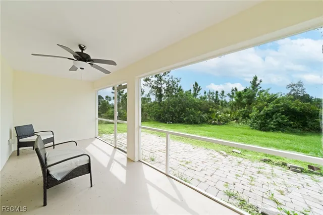 a view of a chairs and table in patio with a yard