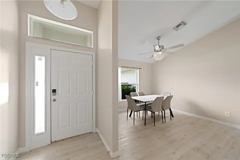 a dining room with furniture and chandelier