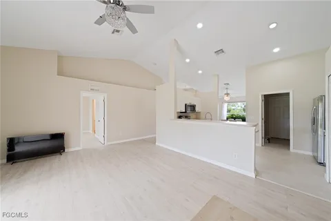 a view of kitchen with refrigerator and ceiling fan