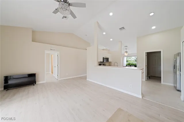 a view of kitchen with refrigerator and ceiling fan