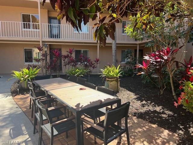1075 Foxfire Lane, Unit 101 Naples, FL 34104 - Photo 3 of 12 View of patio / terrace with outdoor dining area