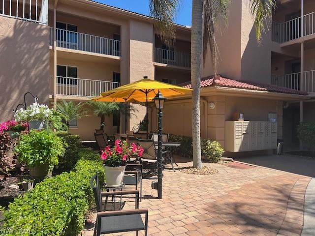 1075 Foxfire Lane, Unit 101 Naples, FL 34104 - Photo 4 of 12 View of patio / terrace featuring mail area