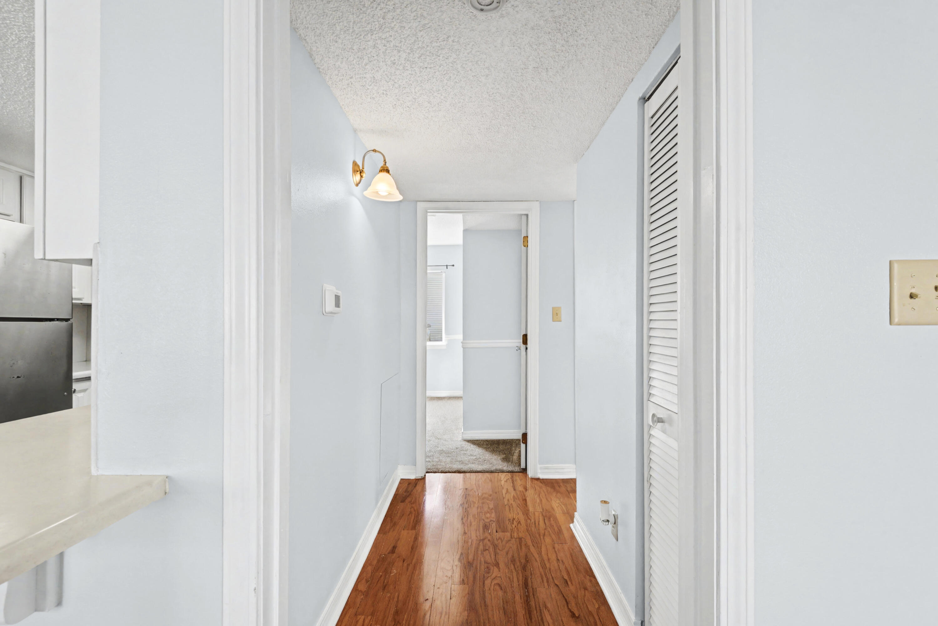 101 Old Ferry Road, Unit 10B Shalimar, FL 32579 - Photo 11 of 29 a view of a hallway with wooden floor and staircase
