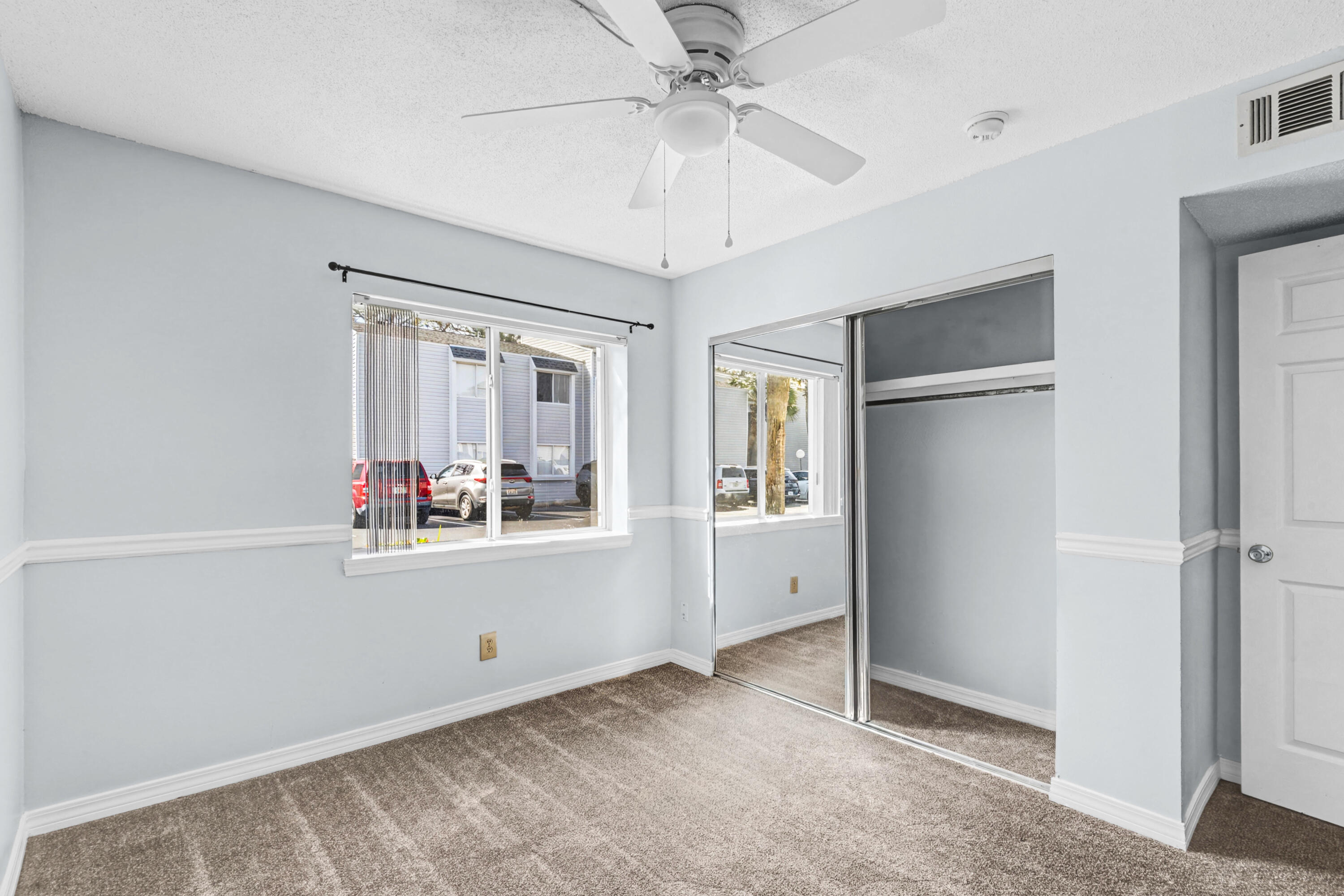 101 Old Ferry Road, Unit 10B Shalimar, FL 32579 - Photo 13 of 29 a view of a livingroom with wooden floor and a ceiling fan