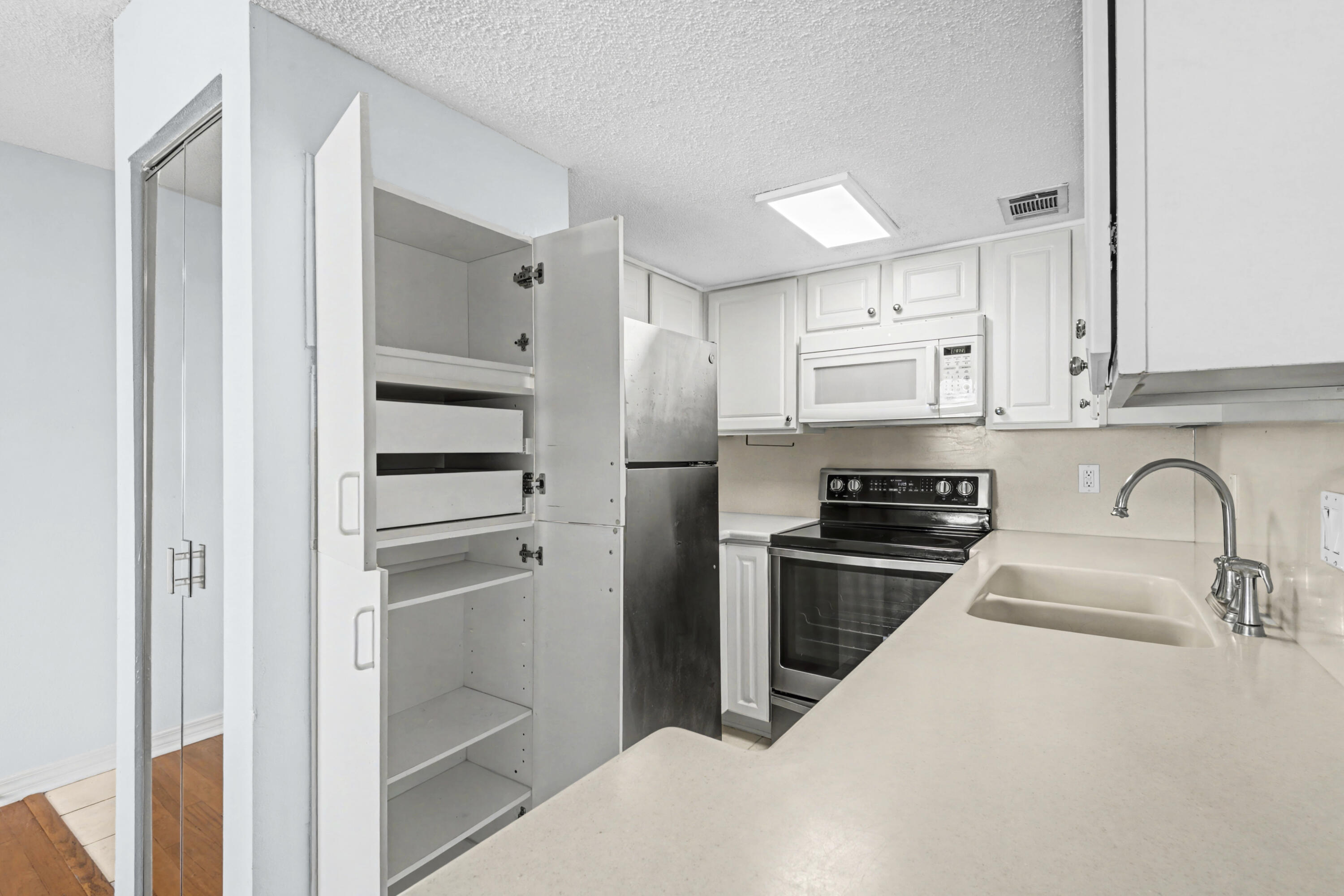 101 Old Ferry Road, Unit 10B Shalimar, FL 32579 - Photo 9 of 29 a kitchen with stainless steel appliances granite countertop a refrigerator and a sink