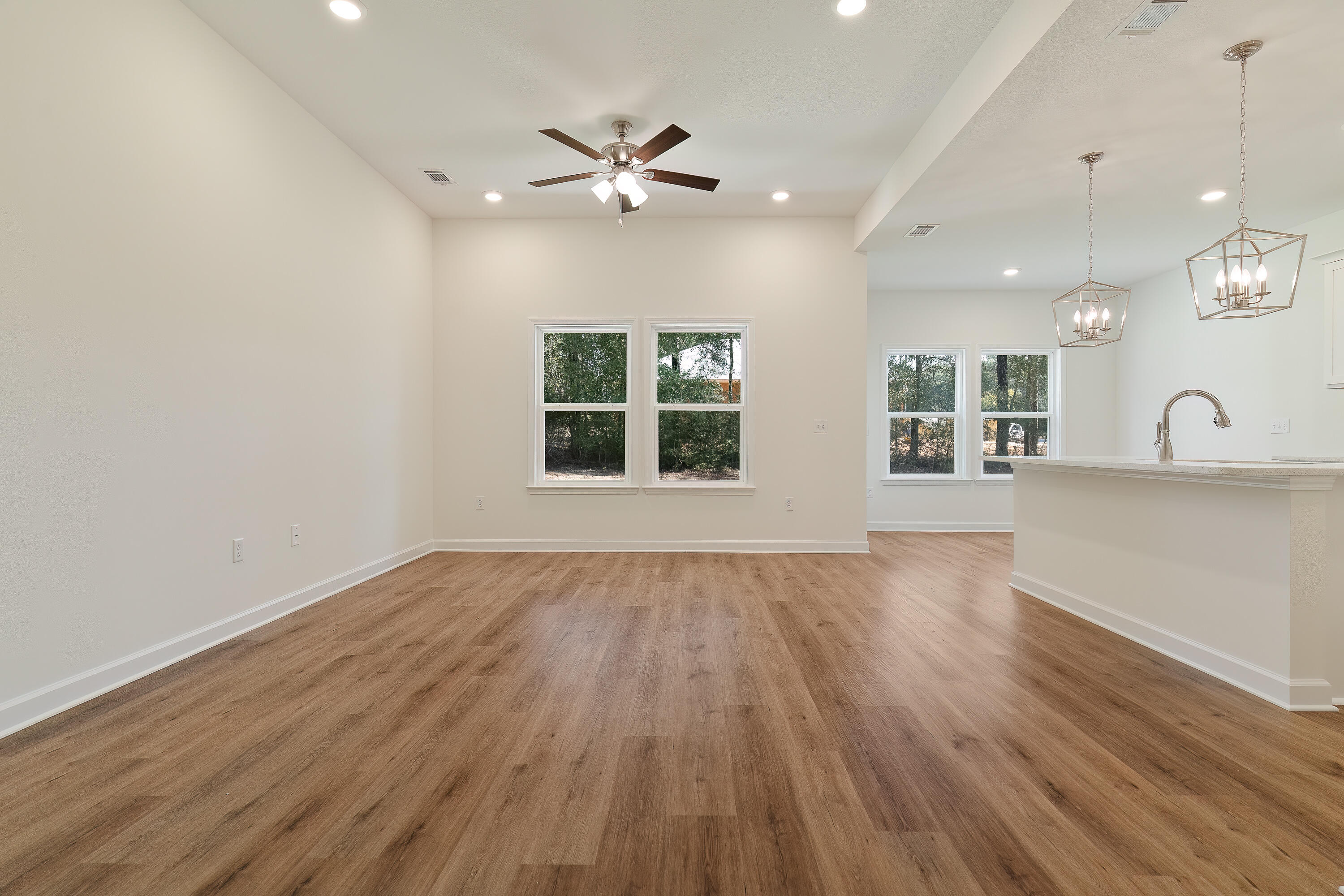 6430 Kylito Circle Crestview, FL 32539 - Photo 4 of 18 an empty room with wooden floor and windows