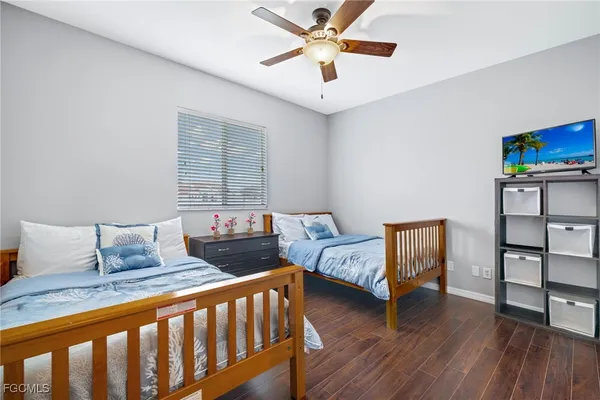 a bedroom with furniture and wooden floor