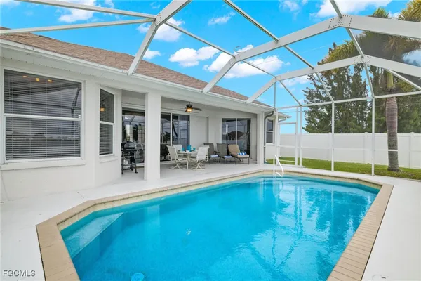 a view of swimming pool with outdoor seating