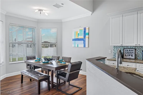 a dining room with furniture and window