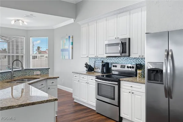 a kitchen with a sink stove and refrigerator