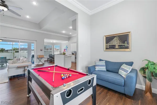 a living room with furniture and kitchen view