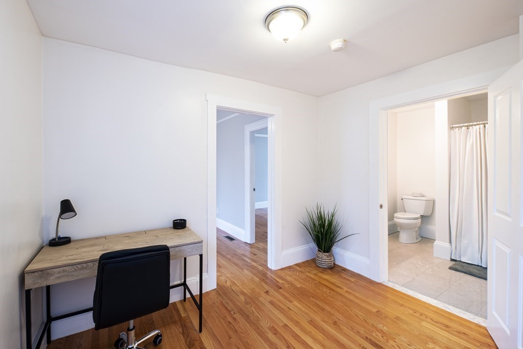 146 Lincoln Road, Unit A Lincoln, MA 01773 - Photo 4 of 11 a bedroom with a bed and a potted plant