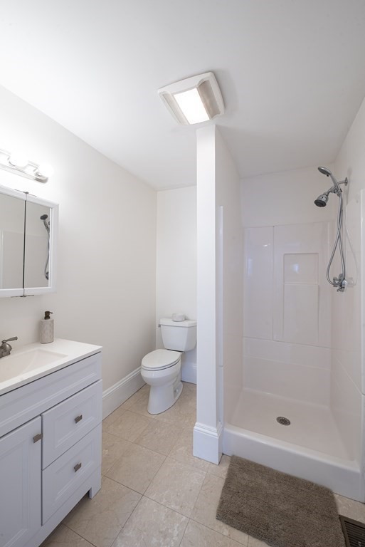 146 Lincoln Road, Unit A Lincoln, MA 01773 - Photo 5 of 11 a bathroom with a double vanity sink toilet and shower