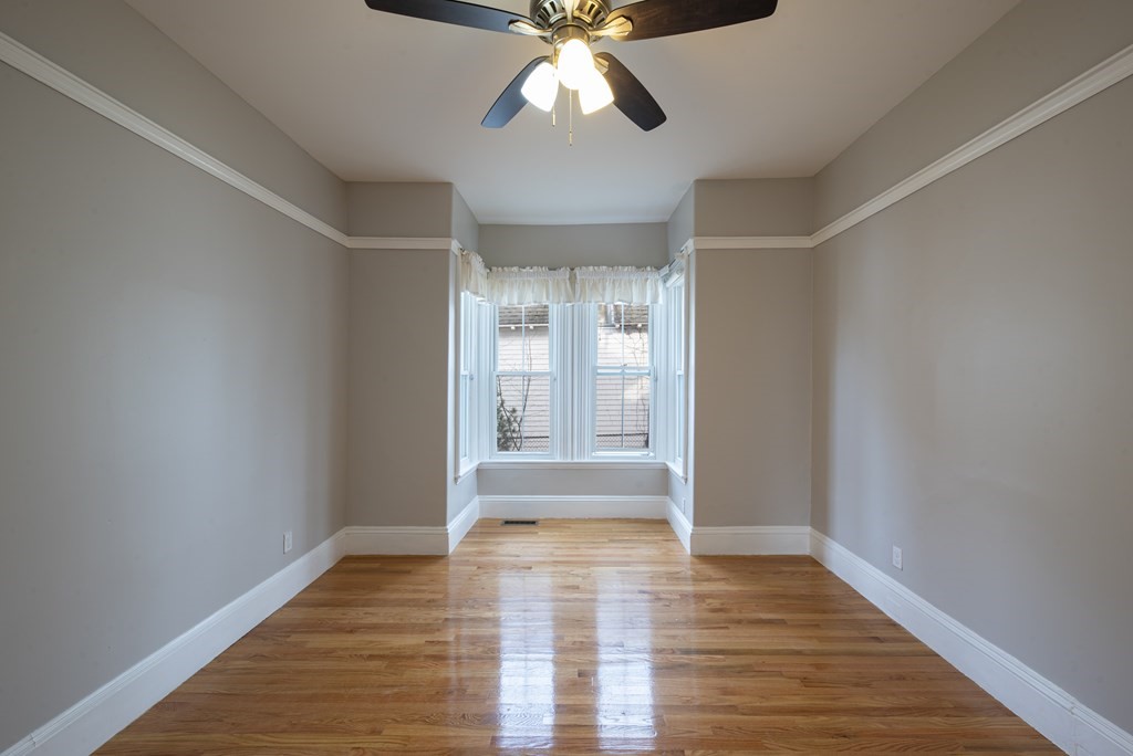146 Lincoln Road, Unit A Lincoln, MA 01773 - Photo 7 of 11 a view of an empty room with wooden floor and window