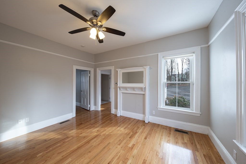 146 Lincoln Road, Unit A Lincoln, MA 01773 - Photo 8 of 11 a view of an empty room with wooden floor and a window