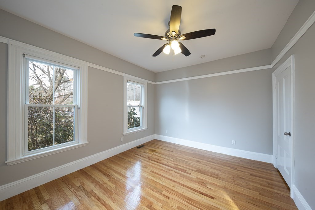 146 Lincoln Road, Unit A Lincoln, MA 01773 - Photo 9 of 11 a view of empty room with wooden floor and fan