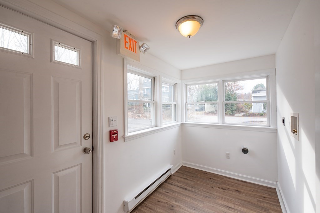 146 Lincoln Road, Unit A Lincoln, MA 01773 - Photo 10 of 11 a view of an empty room with wooden floor and a window