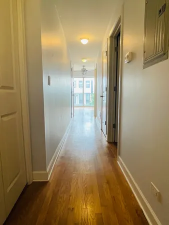 a view of a hallway with wooden floor