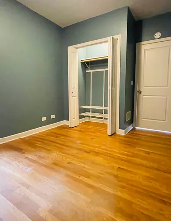 a view of a room with wooden floor and fan