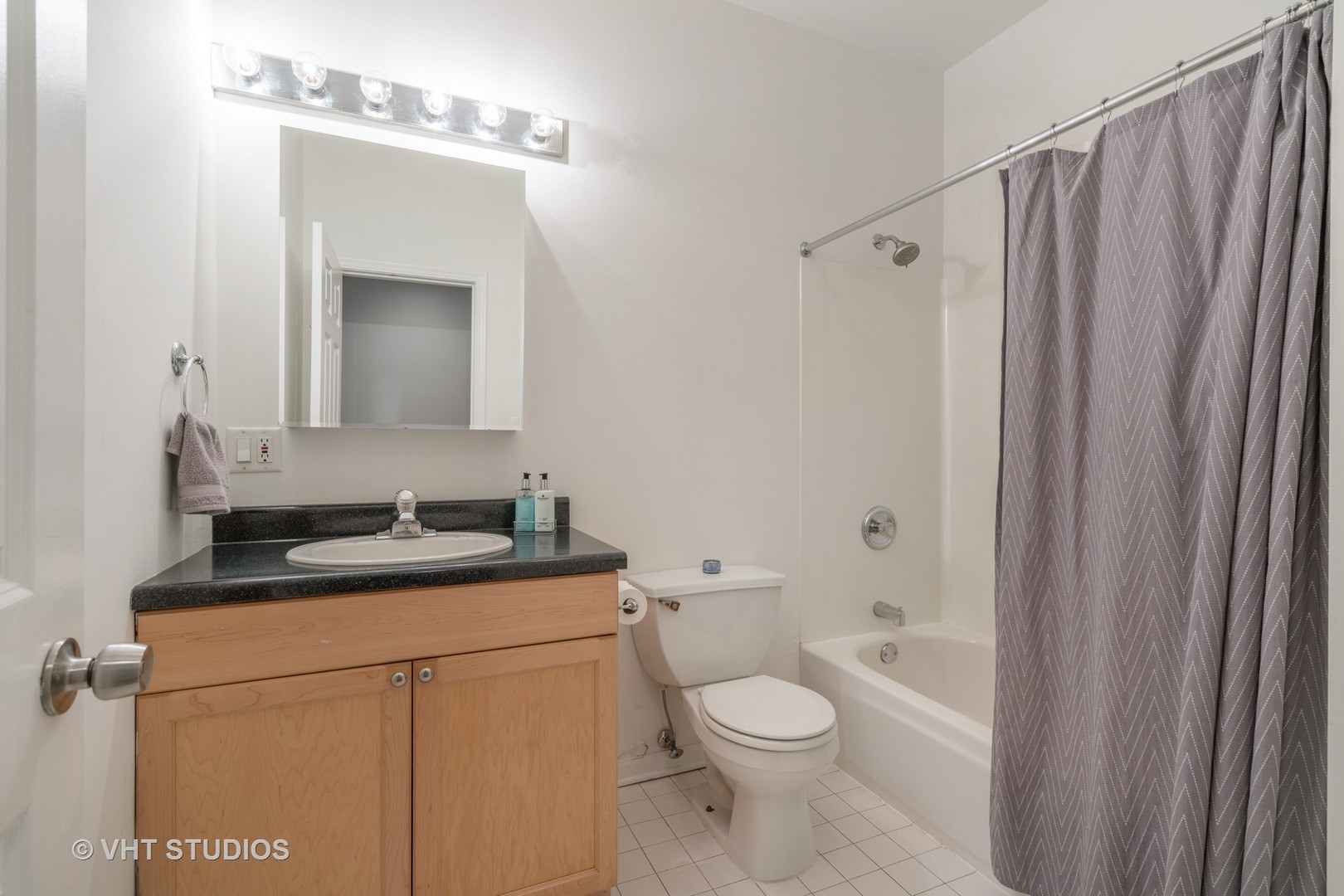 1048 West Fulton Market, Unit 3 Chicago, IL 60607 - Photo 14 of 16 a bathroom with a granite countertop sink toilet and shower