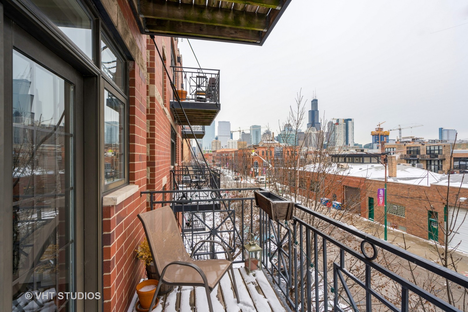 1048 West Fulton Market, Unit 3 Chicago, IL 60607 - Photo 15 of 16 a city view from a balcony with wooden floor